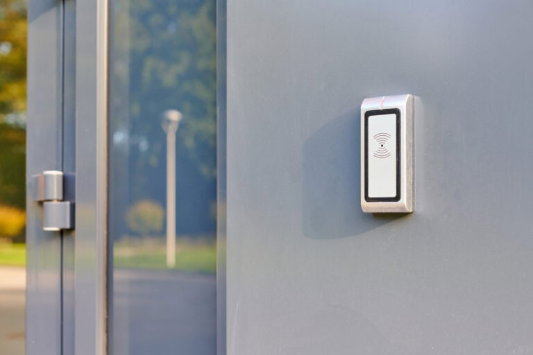 RFID reader at office entrance for access by RFID key card, lock and key control system. RFID door lock security identification system. Employees only access