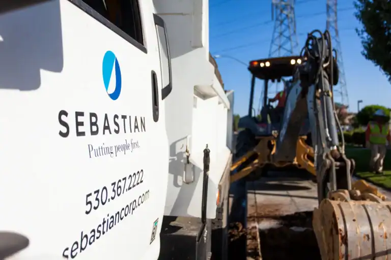 Sebastian Corp construction vehicle and excavator at a job site