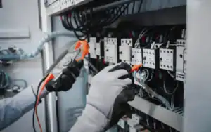 Electrician performing commercial electrical maintenance on an electrical panel