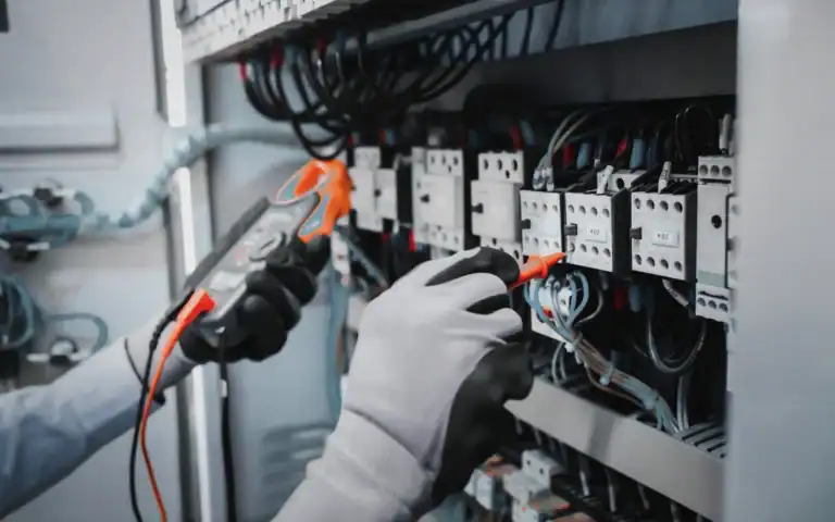 Electrician performing commercial electrical maintenance on an electrical panel