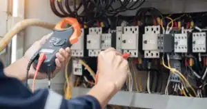 Technician terminating and labeling cable at a patch panel