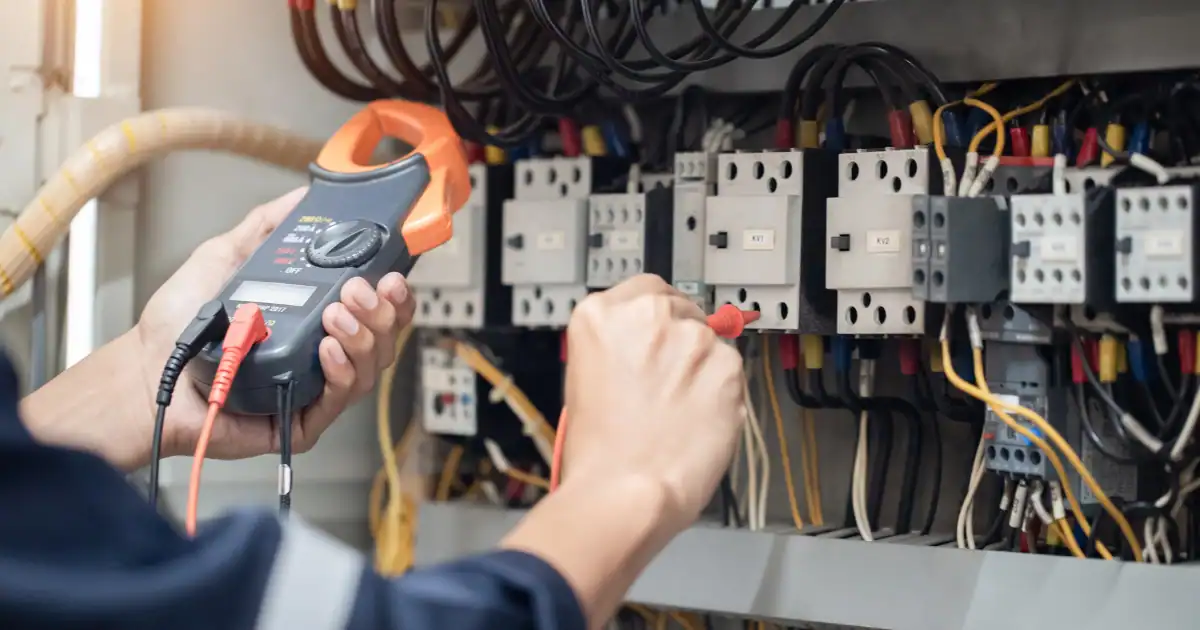 Technician terminating and labeling cable at a patch panel